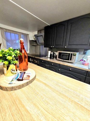 a bottle of alcohol sitting on a counter in a kitchen at Charmant studio 30m2 in Clermont-Ferrand