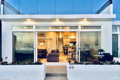 a living room and dining area of a house at Beachfront Boutique Villa Cazadores in Rosarito