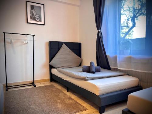 a bed in a room with a window at G&G Homely Apartment Horhausen Westerwald - near A3 in Horhausen