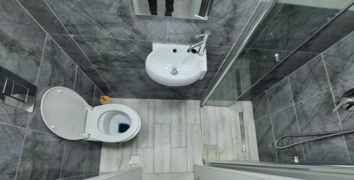a bathroom with a toilet and a sink at kikar natanya in Netanya