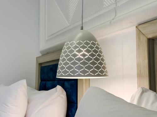 a pendant light hanging over a bed in a bedroom at Petra Karam Hotel in Wadi Musa