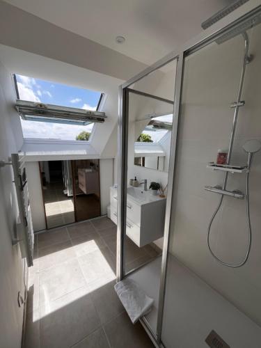 a bathroom with a shower and a mirror at Chez Maurice - Stylish French Country House in Cherrueix