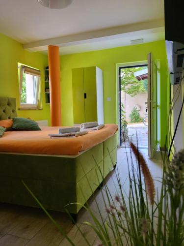 a bedroom with a large bed and green walls at Villa Vino & Grad in Zagreb