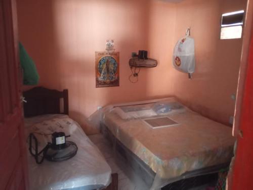 a room with two beds and a phone on the wall at Solar dos Rabelo in Belém