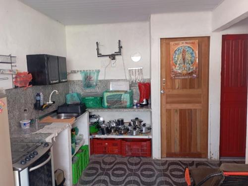 a small kitchen with a red door and a counter at Solar dos Rabelo in Belém