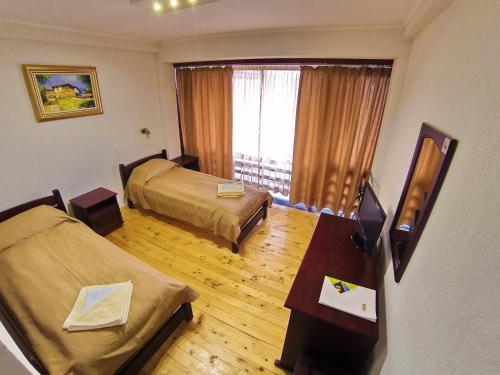 a hotel room with two beds and a window at Rumika Ecocenter in Elkhovo