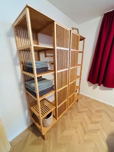 a wooden book shelf with folded towels in a room at Haus Steiner #Mitten im Schwarzwald# in Lauterbach