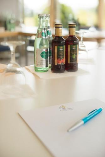 three bottles of alcohol sitting on top of a table at Hotel St Elisabeth in Allensbach