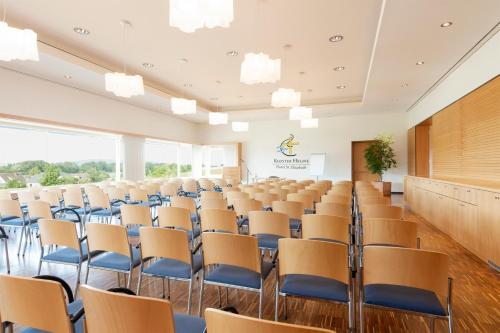 an empty room with chairs and a podium at Hotel St Elisabeth in Allensbach