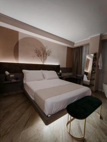 a bedroom with a large bed and a chair at EFFE4 Lovely Room in Bari