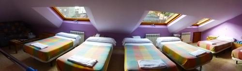 a room with four beds in a attic at Hostal Ciudad de Nájera in Nájera