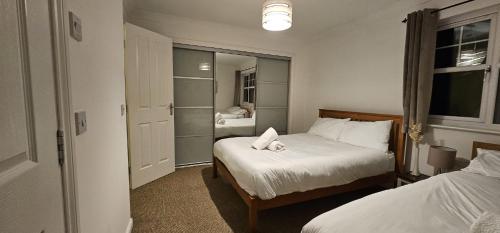 a small bedroom with two beds and a window at Sun Gardens Retreat- can sleep 10 with 4 Double Beds & 2 sofa beds in Stockton-on-Tees