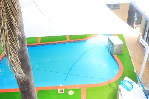 a large swimming pool in a resort at Musina Crown Guest House in Musina