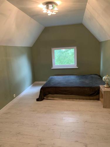 a bedroom with a bed and a window at Czy apartament in Eidsberg 1 hour from Oslo in Eidsberg