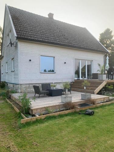 a house with a wooden deck in front of it at Czy apartament in Eidsberg 1 hour from Oslo in Eidsberg