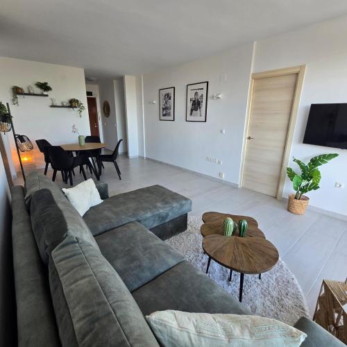 a living room with a couch and a table at Marbella city center appartment walking distance beach and plaza de los naranjos in Marbella