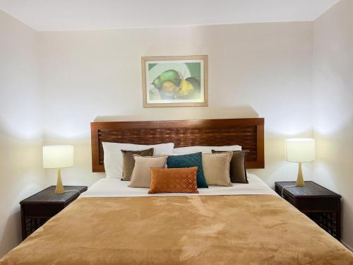 a bedroom with a large bed with two lamps at Discover The Best Area of Coronado with Pool in Chame