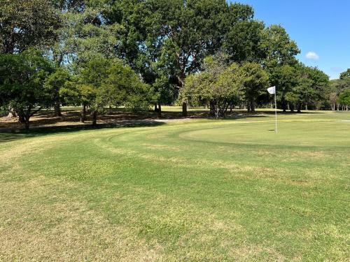 a golf course with a flag in the middle of a field at Discover The Best Area of Coronado with Pool in Chame