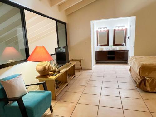 a room with a bed and a tv and a chair at Discover The Best Area of Coronado with Pool in Chame