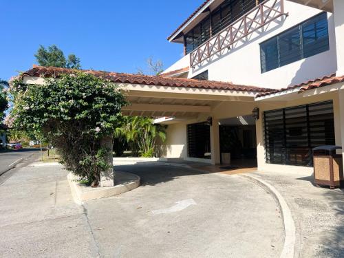 a large white building with a tree in front of it at Discover The Best Area of Coronado with Pool in Chame