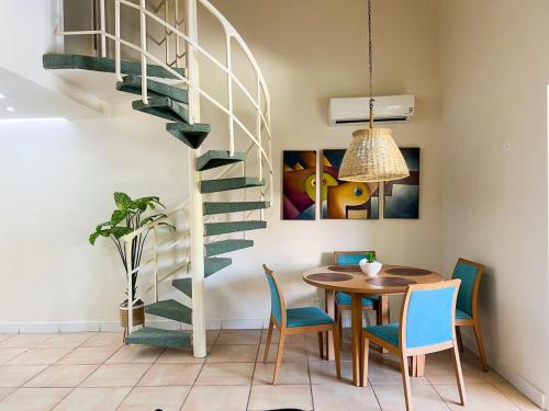 a dining room with a table and a spiral staircase at Discover The Best Area of Coronado with Pool in Chame
