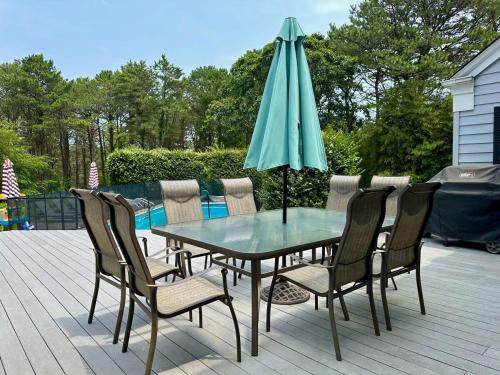a table and chairs with an umbrella on a patio at Southampton Family Estate in Southampton