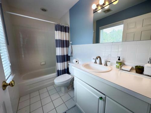 a bathroom with a sink and a toilet and a mirror at Southampton Family Estate in Southampton