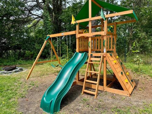 a playground with a green slide and a ladder at Southampton Family Estate in Southampton
