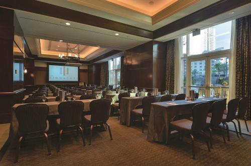 a conference room with tables and chairs and a projection screen at MGM SIGNATURE - Strip View Suite- FREE valet parking in Las Vegas