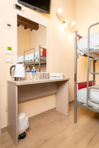 a room with a vanity with a mirror and bunk beds at Affittacamere Il Tiro a Segno in Norcia
