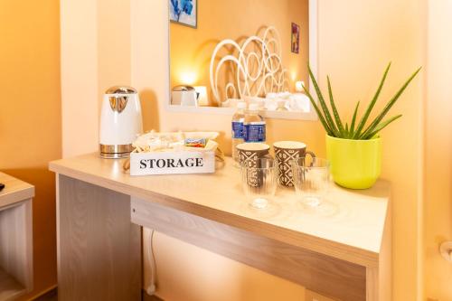 a counter in a room with a table with cups at Affittacamere Il Tiro a Segno in Norcia