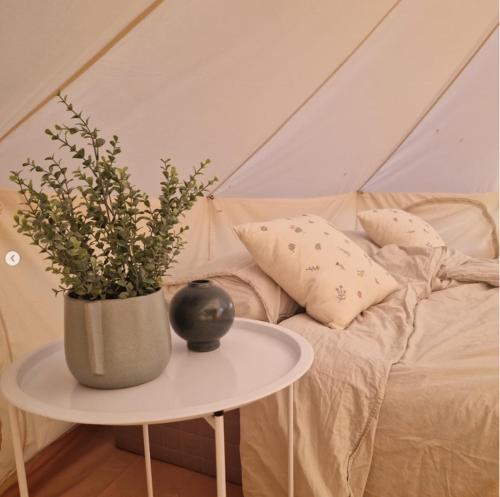 a vase on a table next to a couch at Bergs Slussar Glamping in Vreta Kloster
