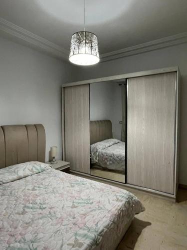 a bedroom with a bed and a large mirror at carfort House in Al Jafr
