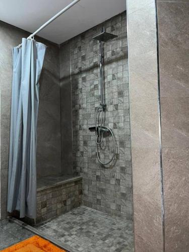 a bathroom with a shower with a shower curtain at carfort House in Al Jafr