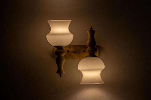 two lights are hanging on a wall at Xotic Resort in Kurunegala