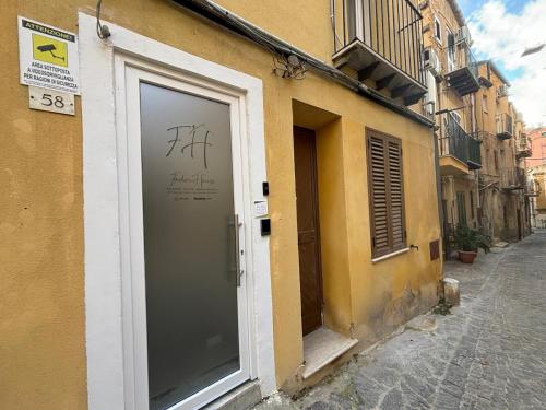 a door to a building with graffiti on it at Foder'House Design Suite in Agrigento