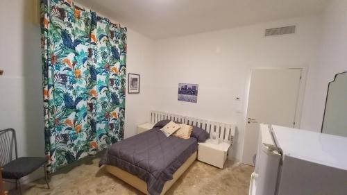 a bedroom with a bed and a shower curtain at Matrimoniale francese con bagno privato in Noicattaro