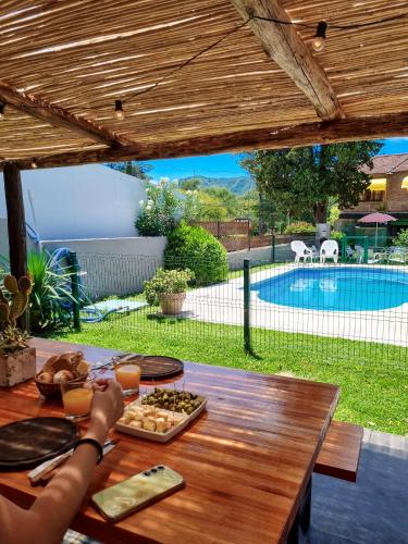 a wooden table with a tray of food on it at POSADA NEHUEN in Villa General Belgrano