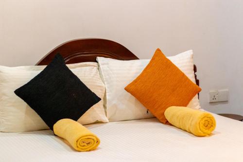 a bed with pillows and towels on top of it at Xotic Resort in Kurunegala