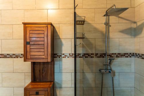 a bathroom with a shower with a wooden cabinet at Évasion Créole à Saint-André II - Parking - Clim in Saint-André