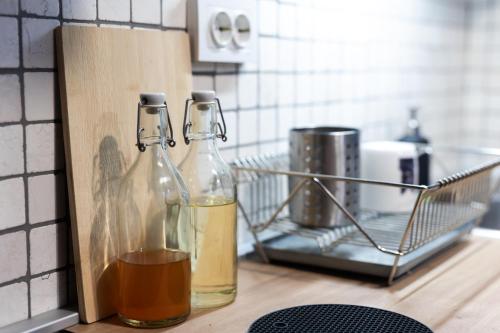 two bottles of vinegar on a counter in a kitchen at Cozy apartment AVOCADO Osijek - Self check in in Osijek