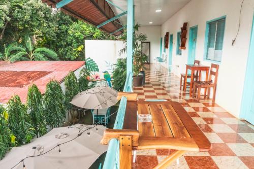 an outdoor patio with a wooden table and chairs at Hostal Edén in Moyogalpa