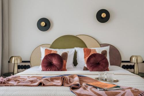 a bedroom with a large bed with pillows on it at Colette - LoftAffair Collection in Warsaw