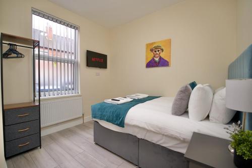 a bedroom with a large bed and a window at Monks Villa Fully Furnished Home Coventry in Coventry