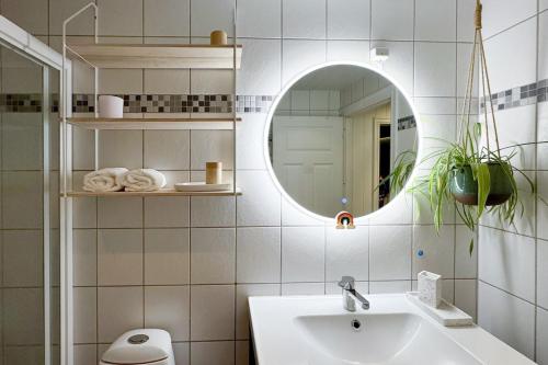 a bathroom with a sink and a mirror at Cozy and Central Loft in Tromsø in Tromsø