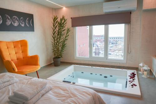 a bedroom with a large bath tub in a window at THE LOT luxury suites in Thessaloniki