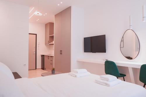 a white room with two chairs and a mirror at THE LOT luxury suites in Thessaloniki