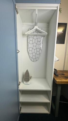 a walk in closet with a white door and a drawer at Bedsit Birmingham in Oldbury