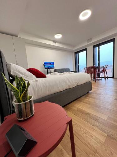 a bedroom with a large bed and a table and chairs at LikeHome PortaReno Monolocale Exclusive - 4 pxs in Ferrara