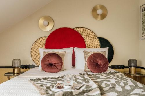 a bedroom with a large bed with a red headboard at Colette - LoftAffair Collection in Warsaw